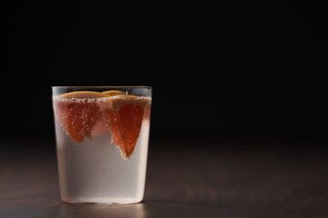 Grapefruit lemonade in tumbler glass on wood table