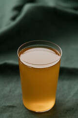 orange lemonade in a tumbler glass on linen cloth