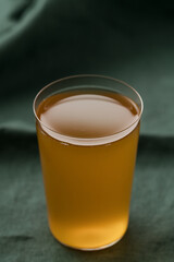orange lemonade in a tumbler glass on linen cloth