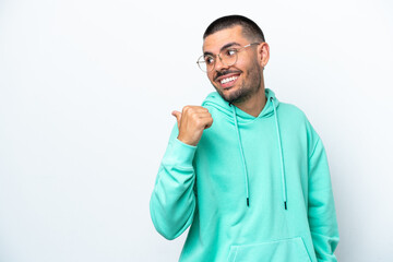 Fototapeta premium Young caucasian man isolated on white background pointing to the side to present a product