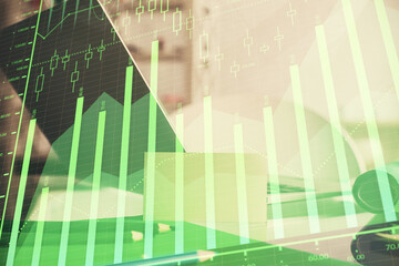 Forex market chart hologram and personal computer background. Double exposure. Concept of investment.