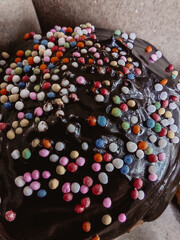 assorted donuts with chocolate frosted, pink glazed and sprinkles donuts.