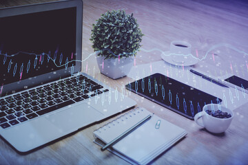 Forex market chart hologram and personal computer background. Double exposure. Concept of investment.