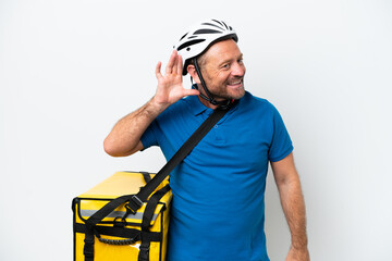 Fototapeta na wymiar Middle age caucasian man with thermal backpack isolated on white background listening to something by putting hand on the ear
