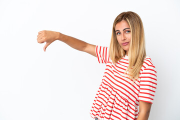 Blonde Uruguayan girl isolated on white background showing thumb down with negative expression