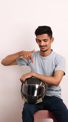 Indian collage boy wears black helmet or head protection gear for safety on white background with different expressions also person pointing by hand to helmet copy space proud and confident