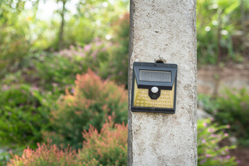 Automatic solar cell lighting bulb that installed along pedestrian walkway in the public park. Technology and object photo.