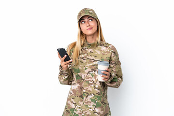 Military woman isolated on white background holding coffee to take away and a mobile while thinking...