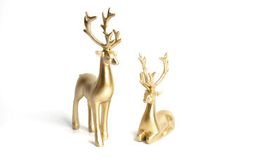 two gold ceramic statuette deer on white