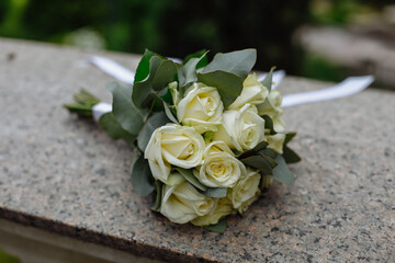 wedding bouquet and shoes of the bride on the background of the road