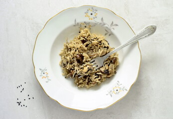 Basmati rice with brown mushrooms and sesame seeds on a gray stone background, top view, copy space