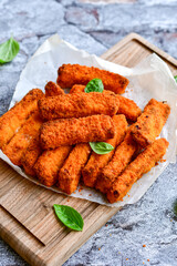 Close up of   Crispy breaded  deep fried fish fingers with breadcrumbs served  with remoulade sauce and  lemon Cod Fish Nuggets on rustic wood table background
