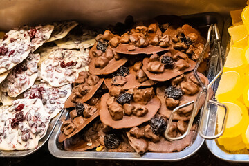 handmade dark and white chocolate with filling on a pastry chef's tray