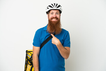 Young reddish caucasian man with thermal backpack isolate don white background with surprise facial expression