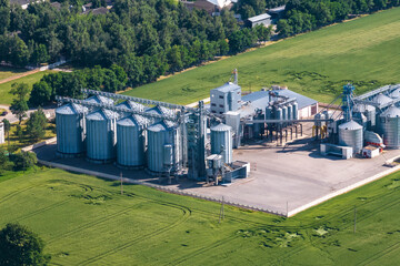 aerial view on agro silos granary elevator on agro-processing manufacturing plant for processing drying cleaning and storage of agricultural products, flour, cereals and grain. © hiv360