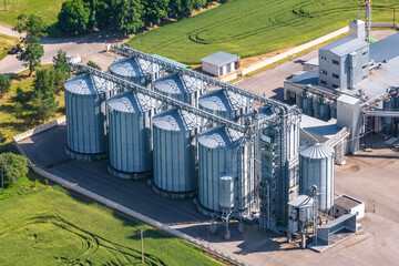 aerial view on agro silos granary elevator on agro-processing manufacturing plant for processing drying cleaning and storage of agricultural products, flour, cereals and grain. © hiv360
