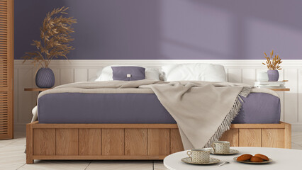 Wooden minimalist bedroom in white and violet tones. Mater bed with blanket close up with copy space. Parquet floor, table with tea cups, breakfast with cookies. Interior design