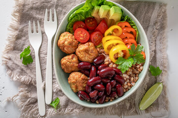Energetic Mexican salad with groats, meatballs, limes and vegetables.