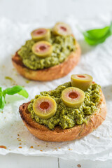 Fresh and tasty bruschetta with black olives as snack.