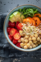Diet salad with groats, chickpeas, arugula and vegetables.