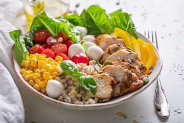 Healthy Caesar salad with groats, chicken and tomatoes.