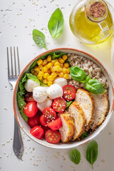Delicious Caesar salad with groats, chicken and tomatoes.