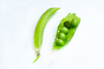 green pea pods on white isolated selective focus,