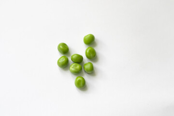 green peas peeled grains on isolated background, geometric figure of legumes