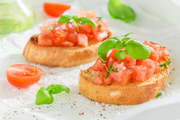 Fresh and hot bruschetta with basil and tomatoes for breakfast.