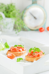 Tasty and fresh bruschetta with tomato and herbs as snack.