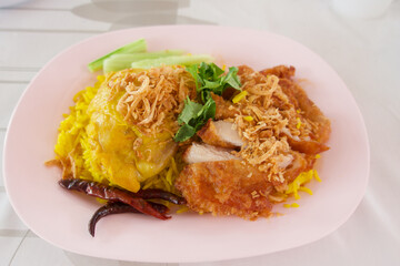 Chicken biryani and deep fry chicken with crispy onion on the rice, Asian food 