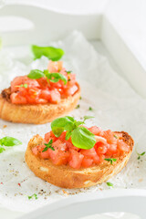 Crisp and healthy bruschetta with tomato and herbs for breakfast.