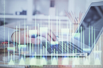 Double exposure of stock market graph with man working on laptop on background. Concept of financial analysis.