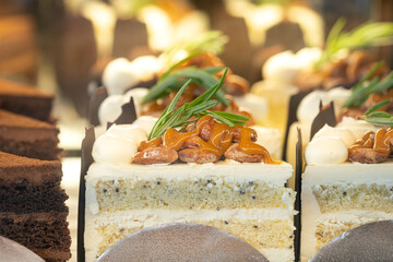 A sliced piece of almond nut vanilla butter cake selling at the sweet cafe shop. ฺBakery food...