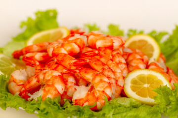 Appetizing dish with boiled shrimp, lettuce and lemon.