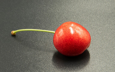 Fresh cherry photographed against a dark background