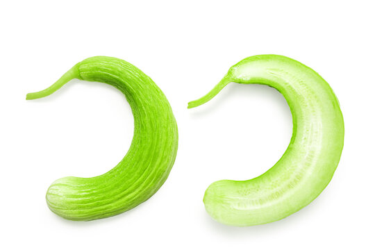 Sliced and halved Armenian cucumber or snake melon with fruit pulp, isolated with clipping path on a white background. Group of fresh and delicious crop for a healthy diet