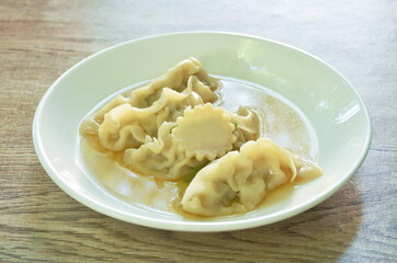  Gyoza Japanese boiled dumplings stuffed chop pork in soup on plate
