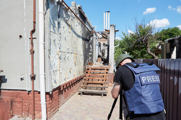 War correspondent photographs destroyed buildings after the bombing in Ukraine. War in Ukraine.