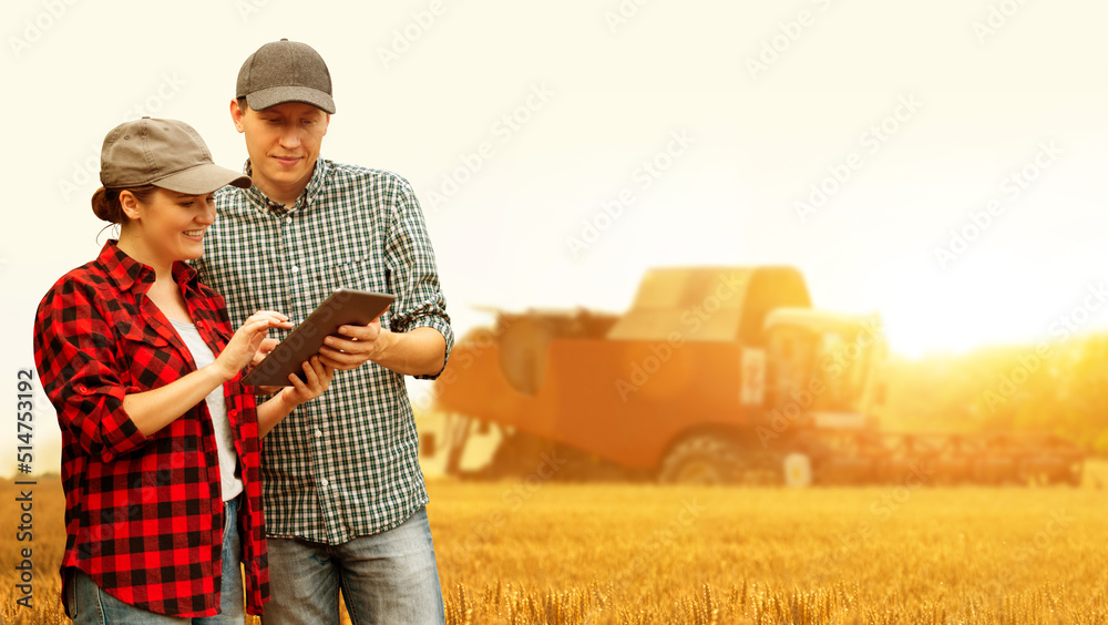 Poster two farmers with digital tablet on a background of combine harvester. smart farming concept.