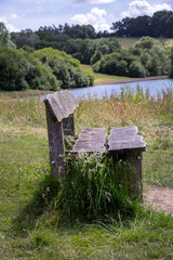 Close up of a wooden bench on the shore of Bewl Water, Kent, England
