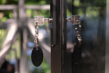 Key with a large oval keychain is inserted into the keyhole. The concept of buying residential real...