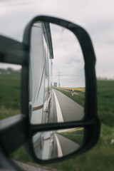 View of the road in the rearview mirror of the motorhome