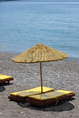 Beach with umbrella and yellow sunbed