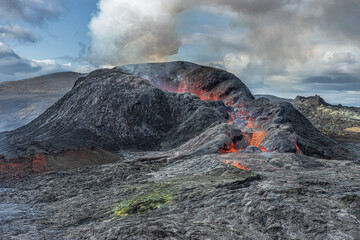 volcano after the eruption. Volcanic landscape on the Reykjanes Peninsula. Active volcano in Iceland with no lava flow. cooled magma around the crater at the day with sunshine and much steam