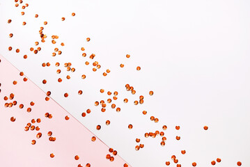 Trendy confetti background. Glitter on pastel pink and white trendy background. Festive background for your projects.