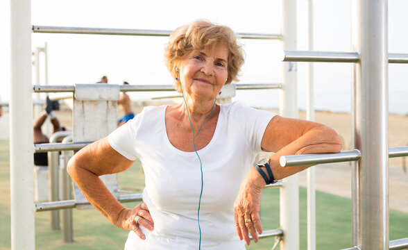 Mature Sportswoman In Workout Station