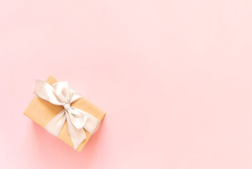 Gift box and confetti on pastel pink background. Birthday party, Valentines day or mother day greeting card. Top view, , copy space