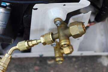 Air conditioner outdoor wall unit filling valves closeup view