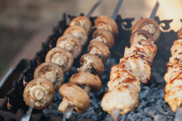 Appetizing mushrooms are fried on the grill....